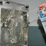 Robotic arm spraying release agent on a hot die casting mold for lubrication and cooling