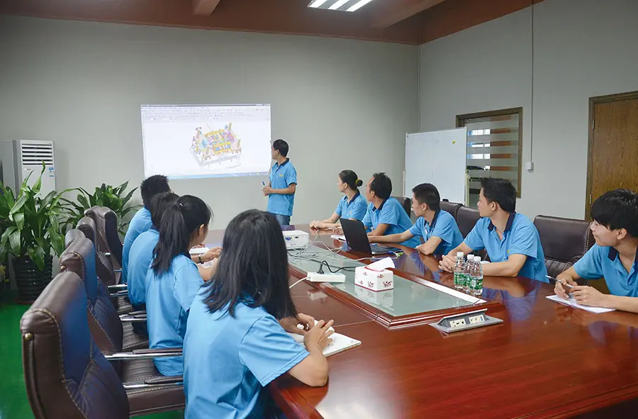 A team of professional engineers evaluated and discussed the manufacturing process of Zamak castings in the conference room.