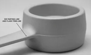 Die casting with flash – thin excess metal protruding from the parting line and ejector pin locations, compared to a trimmed part.
